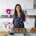 Maya with muffins made with almond flour.